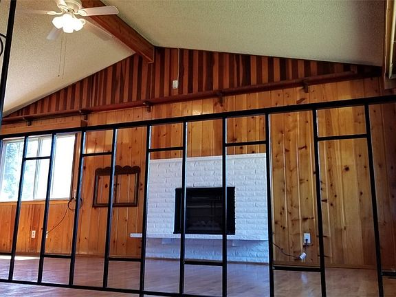 View of living room from split level entry.  Notice the beautiful woodwork and vaulted ceilings. 
