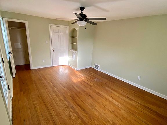 Master bedroom with hardwood floors and built-in