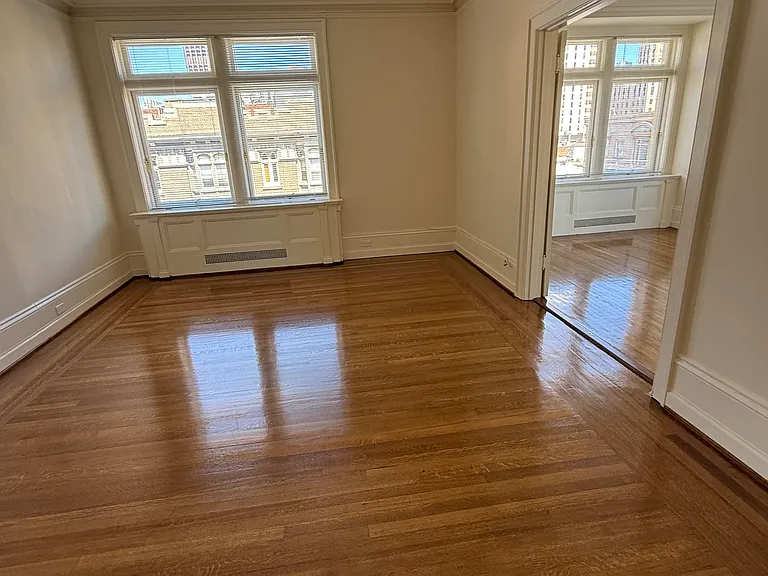 living room through double doors into bedroom