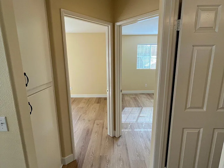 Hall view of upstairs bathroom, bedrooms and large linen closet