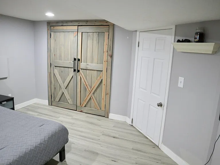 full size closet with reclaimed wood doors
