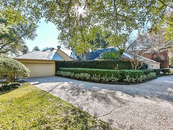 View of the circle driveway and attached 2 car garage.
