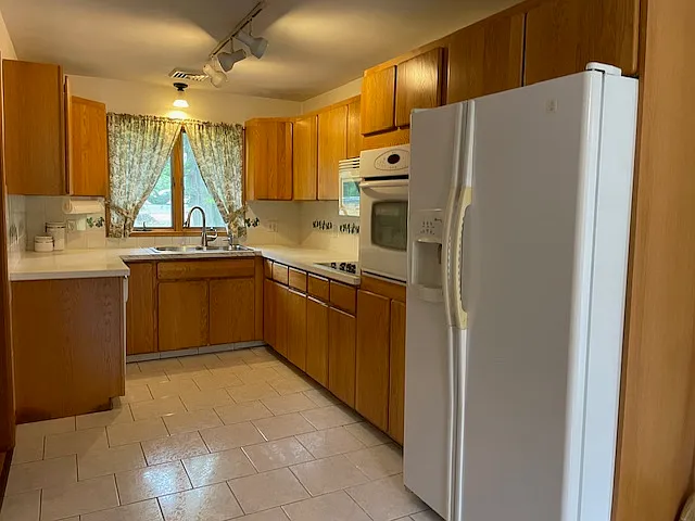 view of kitchen, new electric cooktop, dishwasher, microwave