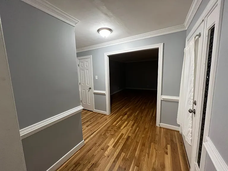 Entry way of home from front door, looking right to living room/office and hall closet pictured on the left.