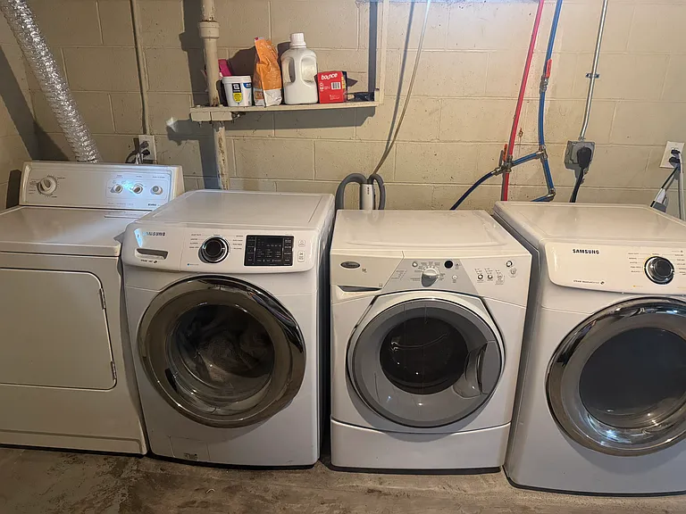 2 sets of laundry appliances in the shared basement