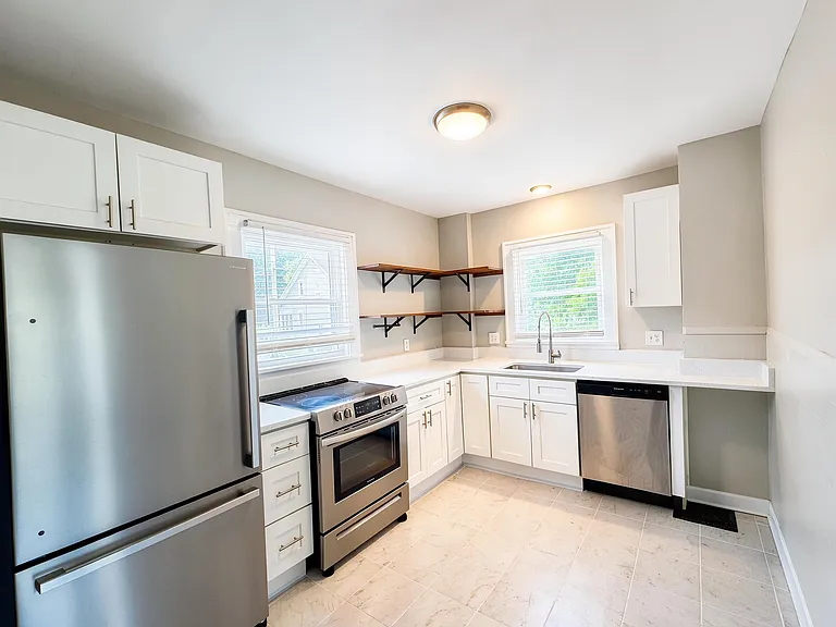 Enjoy cooking in the kitchen with stainless steel appliances and quartz countertops