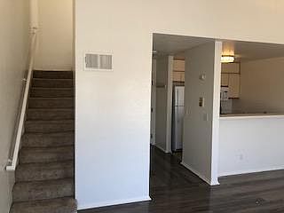 Second floor living room, kitchen and stairway to third floor loft