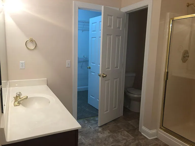 Master bath with view of walk-in closet