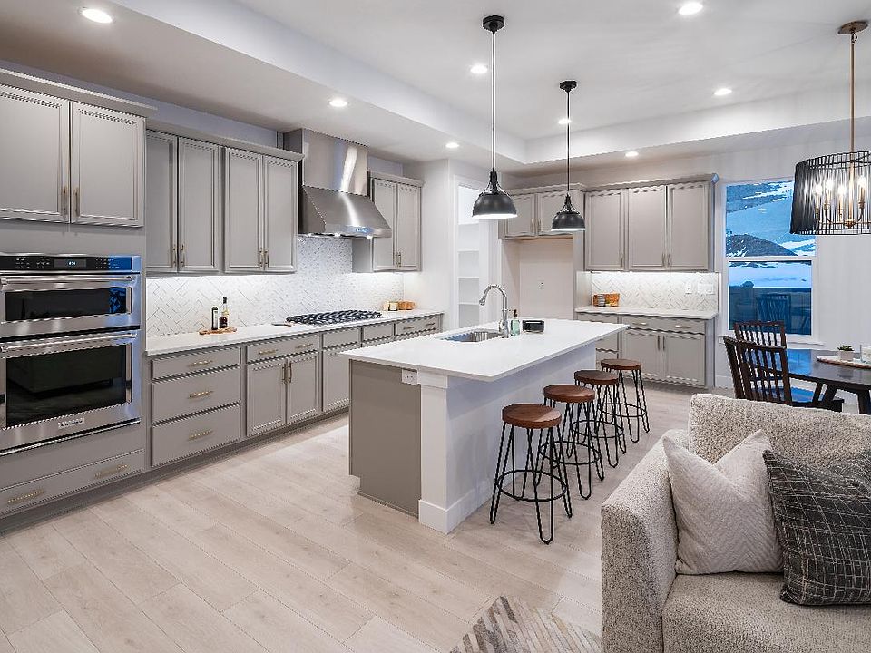 Kitchen with large center island, breakfast bar, and stainless steel appliances