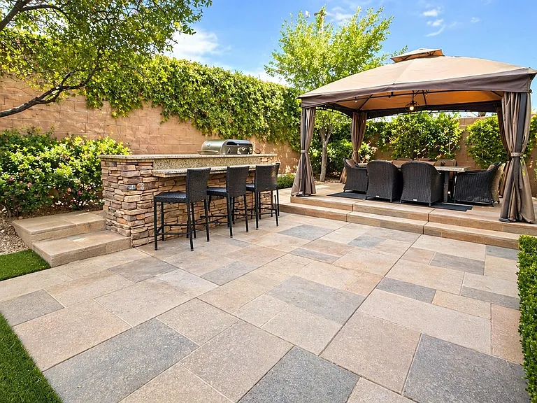 Outdoor kitchen and bar with elevated covered dinning area