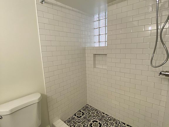Bathroom with tiled shower.