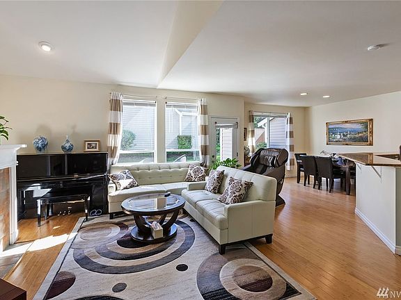 Plenty of light in this open concept living room, dining room and kitchen area. Complete with vaulted ceilings, gas fireplace and bamboo floors. Easy access to your private patio with additional storage.