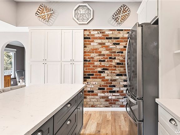 Kitchen with accent real brick wall