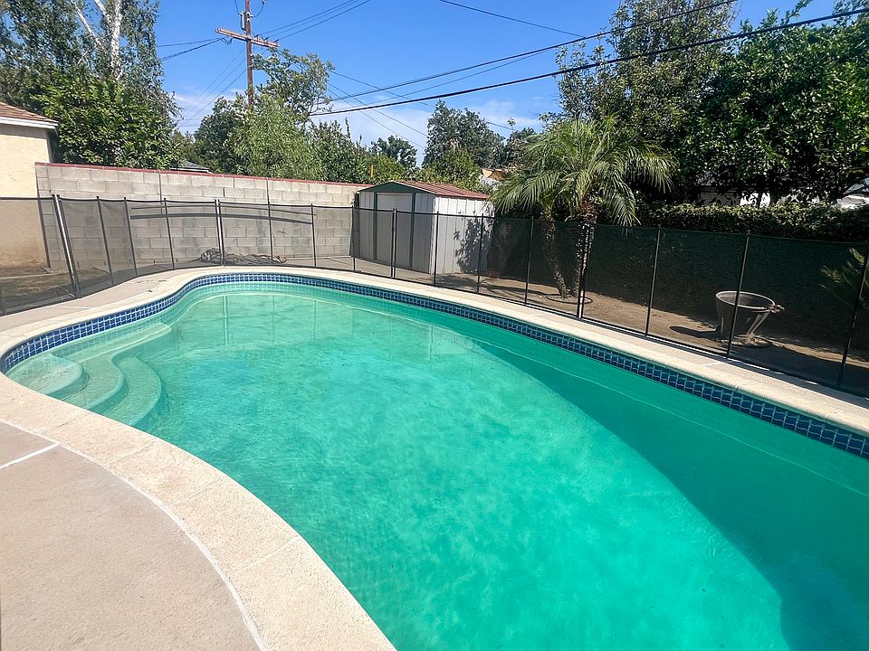 Fenced in pool in the backyard
