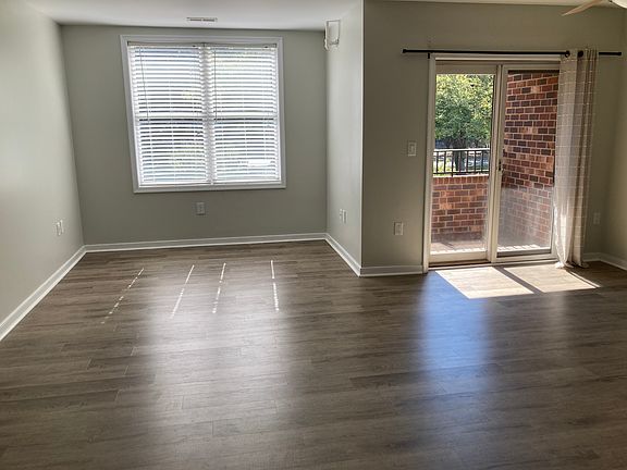 Open living and dining areas with sliding glass door access to private balcony.