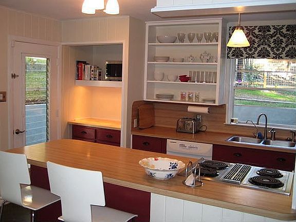 The kitchen has bar dining and overlooks the dining room.