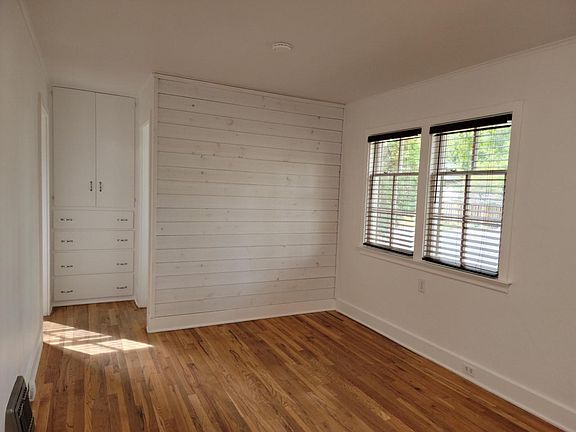 Living room showing front window and ship-lap accent wall.