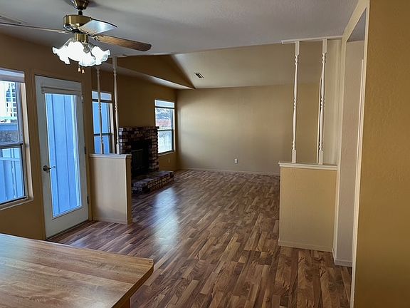 Dining area/living room area with wood-burning fireplace.