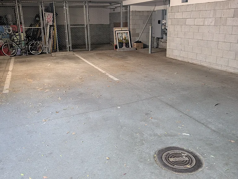 two underground parking spaces with gated storage