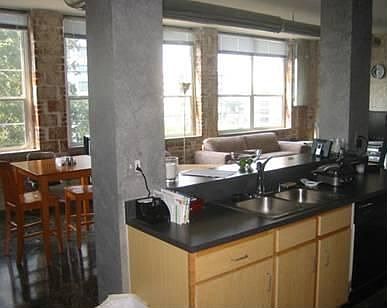 Open Contemporary Kitchen Flows Into The Dining and Living Room