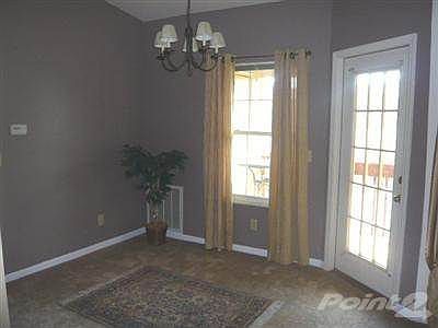 Dining with wall to wall newer carpeting, chandelier, with walk out to covered deck.