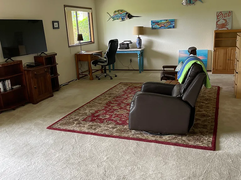 Downstairs with work area, tv,sink and separate room for storage