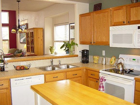 Kitchen with 6" Tile Countertops, smooth-top range/oven, pantry 