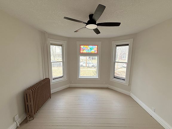 Large windows provide ample natural light and comes with a ceiling fan for ambiance