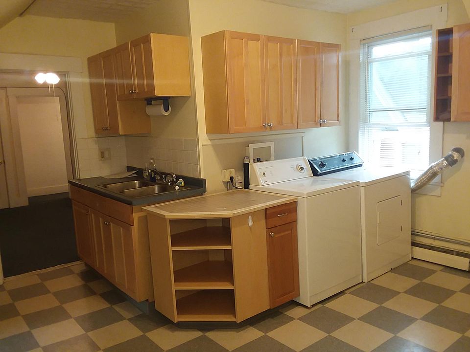 Bright sunny kitchen! 3 windows, this large one faces South, great light. Custom made, tiled corner cabinet, double sink, GFCI outlets, handsome!