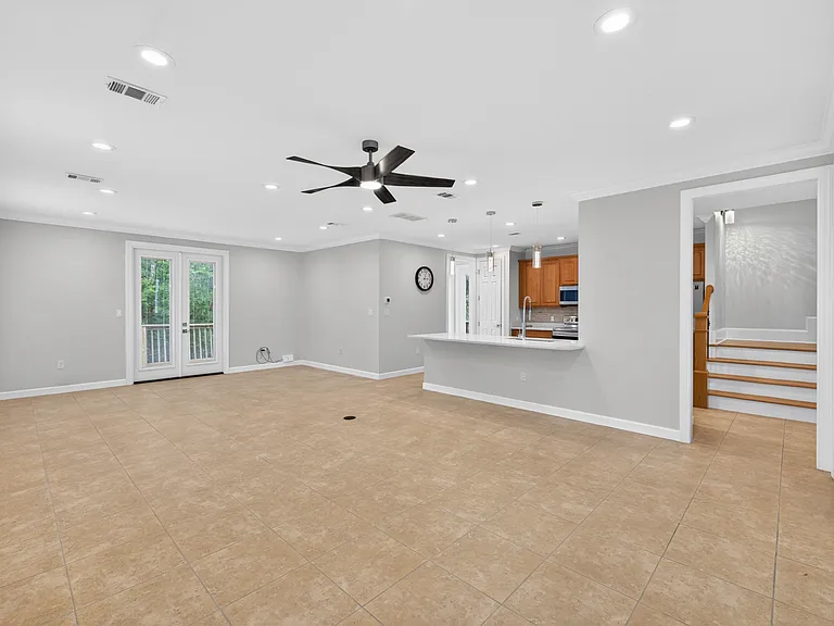 Stairwell with Landing next to Kitchen & Living Areas