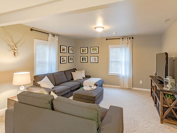 TV end of living area can fit lots of seating. Newer neutral paint, new drapes and rods, and new electrical plugs through out house.  Lots windows let in natural light.  