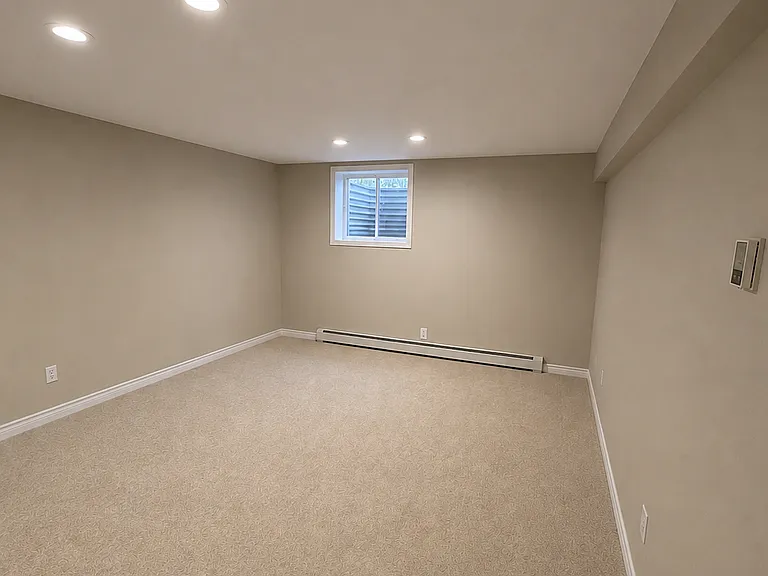 Basement (right view) with window-well in bedroom area