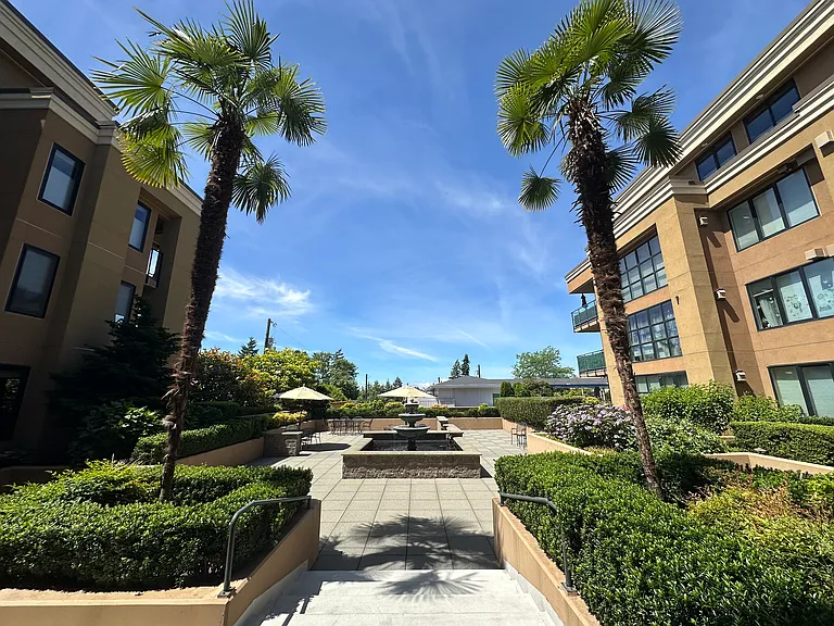 Quite courtyard with tables, chairs and umbrellas