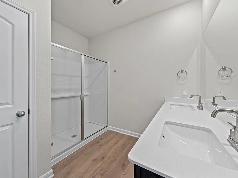 The master bathroom has a glass, walk-in shower.