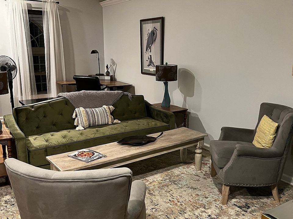 Living area with stand up desk in the corner.