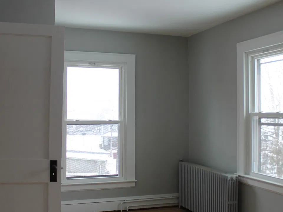 Bedroom located at rear of apartment, north side. 3 windows and a closet.