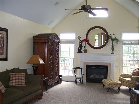 Enormous Living Room w/ Cathedral Ceilings & gas fireplace w/ marble surround.