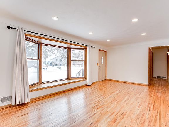Living room with bay window and hardwood floors