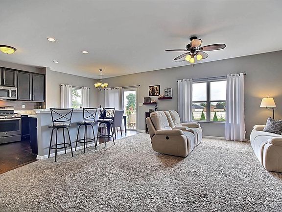 BEAUTIFUL AND WARM OPEN CONCEPT MFLOOR w/UPGRADED WOOD FLOORING, CABINETS, BREAKFAST BAR, STAINLESS STEEL APPLIANCES, LIGHTING, CARPET & MORE!