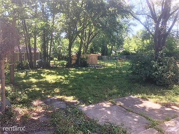 Back yard - fenced in, only 3 sides. Shaded trees, place fo