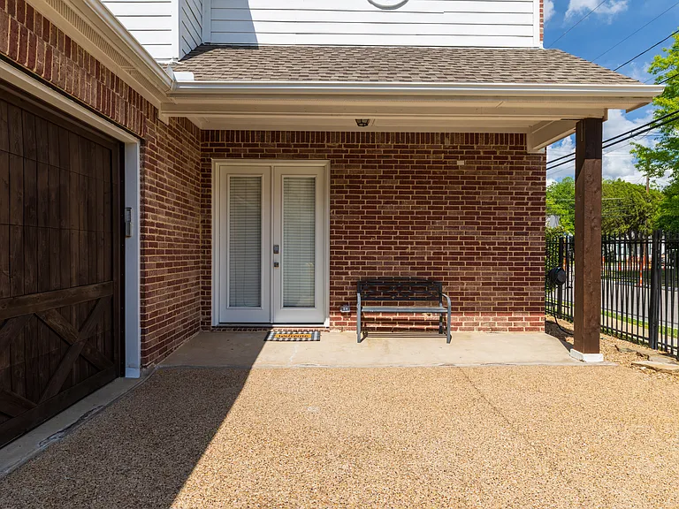 Private side entrance featuring a cozy bench and frosted glass doors