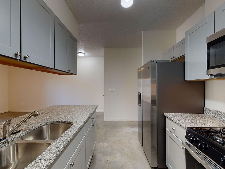 granite countertops and stainless steel kitchen with full size appliances and built-in microwave oven.