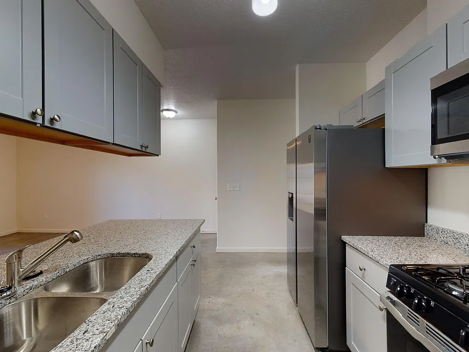 granite countertops and stainless steel kitchen with full size appliances and built-in microwave oven.