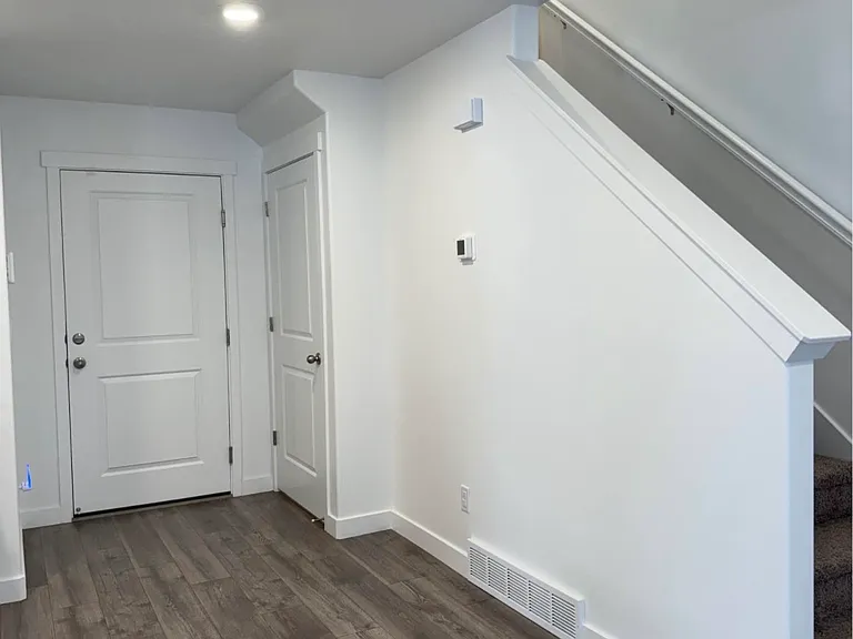 Entry from garage door, closet with crawl space, and stairs