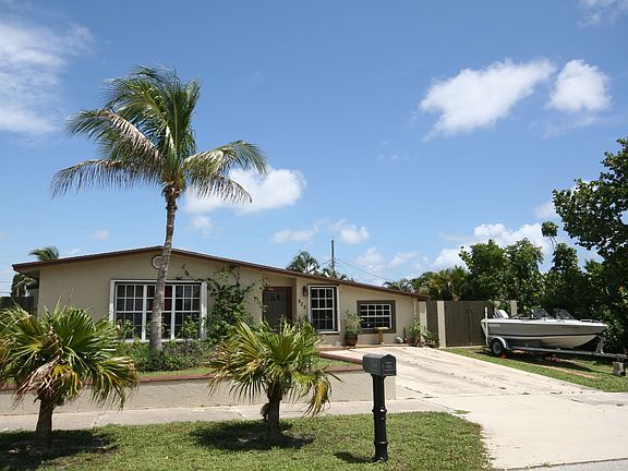 Front of house with paver boat parking area