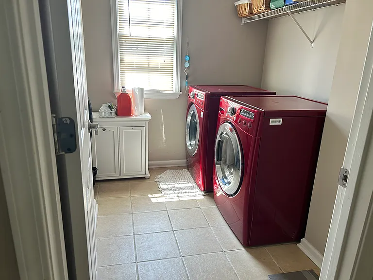 Functional laundry space with washer/dryer, upper shelving and multi-bin hamper for sorting your dirty cloths!