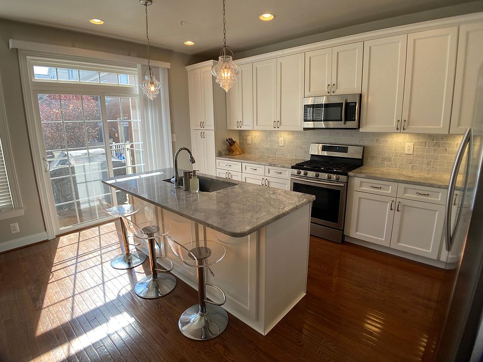 Kitchen with quartzite countertops, marble backsplash