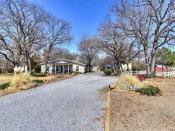 Property with circlular gravel drive.