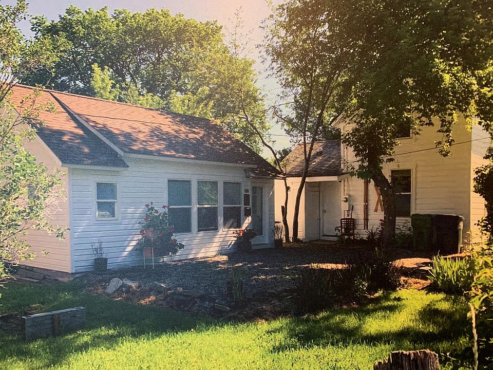 Streetside entrance to the studio. Private yard and deck is around the back. The home of owners Amy and Chris is on the right.