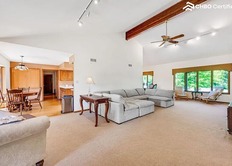 Couch nestled under expansive headspace with ottoman